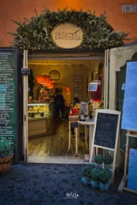Blick durch die Türe in ein Weinlokal das typisch italienisch opulent eingerichtet ist.